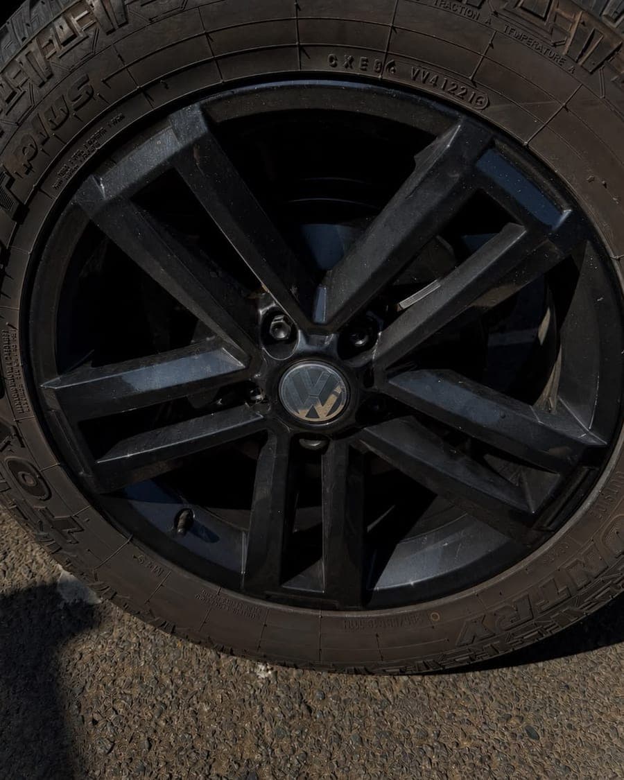 Dusty black Volkswagen alloy wheel before valeting